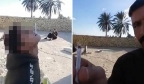 伊拉克男子为秀枪法，让儿子嘴刁香烟当靶子，自己持突击枪射击